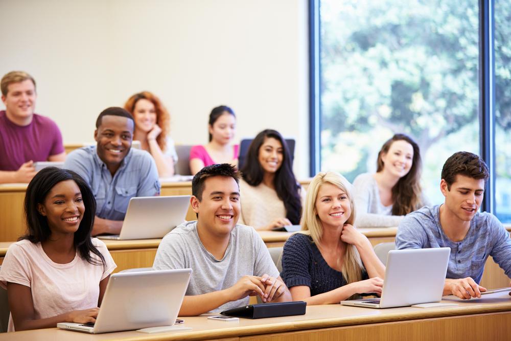 happy students_with computers_shutterstock_218151238